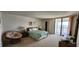 Bright bedroom with ample space, natural light, balcony access, and relaxing sitting area at 3003 S Atlantic Ave # 21A2, Daytona Beach Shores, FL 32118