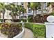 Building entrance surrounded by lush landscaping, and offering a welcoming pathway to the property at 3003 S Atlantic Ave # 21A2, Daytona Beach Shores, FL 32118