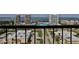 Balcony view showcasing lush trees, cityscape, and waterway at 3003 S Atlantic Ave # 21A2, Daytona Beach Shores, FL 32118