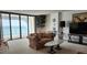 Living room features sliding glass doors with ocean views and neutral carpet at 3003 S Atlantic Ave # 21A2, Daytona Beach Shores, FL 32118