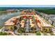 High-angle view of the colorful condo buildings with parking, palm trees, lake with fountains, and manicured grounds at 3049 Meleto Blvd, New Smyrna Beach, FL 32168
