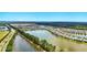 Expansive aerial shot of the community featuring waterways, varied home designs, and lush, green landscapes at 3049 Meleto Blvd, New Smyrna Beach, FL 32168