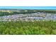 Panoramic aerial view of a community with a lake, surrounded by lush greenery at 3049 Meleto Blvd, New Smyrna Beach, FL 32168