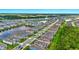 Panoramic aerial view of a lakeside community featuring a mix of blue and neutral-toned homes at 3049 Meleto Blvd, New Smyrna Beach, FL 32168