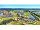Wide aerial view of a community featuring golf courses, lakes, manicured landscapes, and varied home styles at 3049 Meleto Blvd, New Smyrna Beach, FL 32168