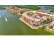 Overhead view of community condo buildings by lake, featuring fountains, parking areas, landscaping, and outdoor seating at 3049 Meleto Blvd, New Smyrna Beach, FL 32168