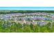 Aerial view showcasing a beautiful community with a serene lake surrounded by lush greenery at 3049 Meleto Blvd, New Smyrna Beach, FL 32168