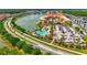 Scenic aerial view showcases the community's lakeside apartments, resort-style pool, and well-maintained landscaping at 3049 Meleto Blvd, New Smyrna Beach, FL 32168