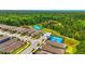 Aerial view of a residential community featuring tennis courts and a scenic greenbelt area at 3049 Meleto Blvd, New Smyrna Beach, FL 32168