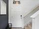 Interior entry showcasing neutral decor, staircase, 'Home Sweet Home' decor, and a modern black and white painting at 3049 Meleto Blvd, New Smyrna Beach, FL 32168