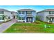 Exterior of a two-story home with a well-maintained lawn and landscaped yard at 3049 Meleto Blvd, New Smyrna Beach, FL 32168