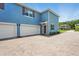 View of home showing the two-car garage, side entry door, and brick-paved driveway at 3049 Meleto Blvd, New Smyrna Beach, FL 32168