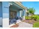Charming front porch with chairs, a fire pit table, and landscaped yard at 3049 Meleto Blvd, New Smyrna Beach, FL 32168