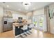 Bright kitchen features a granite countertop island with bar seating, modern stainless steel appliances, and a stylish chandelier at 3049 Meleto Blvd, New Smyrna Beach, FL 32168