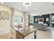 Kitchen island with granite counters and double sink overlooking living area at 3049 Meleto Blvd, New Smyrna Beach, FL 32168