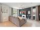 Stylish living room featuring a comfortable gray sofa, fireplace, TV, and modern decor at 3049 Meleto Blvd, New Smyrna Beach, FL 32168