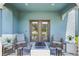 Cozy outdoor patio with cushioned chairs, a table, and a modern fire pit at 3049 Meleto Blvd, New Smyrna Beach, FL 32168