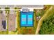 Overhead view of community pickleball courts with blue surface, surrounded by green space near neighborhood homes at 3049 Meleto Blvd, New Smyrna Beach, FL 32168