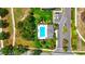 Aerial view of a community pool with lounge chairs, greenery, a parking area, and surrounding landscaped grounds at 3049 Meleto Blvd, New Smyrna Beach, FL 32168