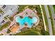 Aerial view of community pool featuring a unique design with palm trees, lounge chairs, and ample deck space at 3049 Meleto Blvd, New Smyrna Beach, FL 32168