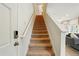Carpeted staircase leading to the upper level of the home, bathed in natural light at 3049 Meleto Blvd, New Smyrna Beach, FL 32168
