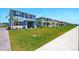 Street view of newly constructed homes with well-manicured lawns, landscaping, and sidewalks at 3049 Meleto Blvd, New Smyrna Beach, FL 32168