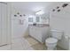 Cozy bathroom with ceramic tile floor, white cabinets, granite counters, and fish decorations at 3145 S Atlantic Ave # 503, Daytona Beach Shores, FL 32118