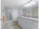 Bright bathroom features double sinks, granite countertops, and a walk-in shower with glass door at 3145 S Atlantic Ave # 503, Daytona Beach Shores, FL 32118