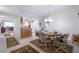 Inviting dining room adjacent to kitchen, with a chandelier and seating for four at 3145 S Atlantic Ave # 503, Daytona Beach Shores, FL 32118
