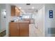 Well-lit kitchen featuring white appliances and plenty of storage with wood cabinets at 3145 S Atlantic Ave # 503, Daytona Beach Shores, FL 32118