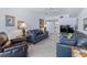 Comfortable living room features leather furniture and a wall-mounted TV for relaxation at 3145 S Atlantic Ave # 503, Daytona Beach Shores, FL 32118