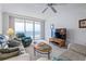 Comfortable living room featuring a ceiling fan, large windows, and ocean views at 3145 S Atlantic Ave # 503, Daytona Beach Shores, FL 32118