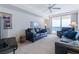 Living room with a large window offering ocean views and comfortable dark blue leather furniture at 3145 S Atlantic Ave # 503, Daytona Beach Shores, FL 32118