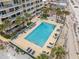 An aerial shot shows a pool and spa alongside palm trees and the beach next to a condo at 3145 S Atlantic Ave # 503, Daytona Beach Shores, FL 32118