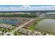 Aerial view showing lakefront homes in the neighborhood, with lush greenery and serene water views at 3229 Medici Blvd, New Smyrna Beach, FL 32168
