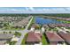 Aerial view of a lovely neighborhood featuring a lake, lush landscaping, and well-maintained homes at 3229 Medici Blvd, New Smyrna Beach, FL 32168