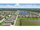 See the community lake with fountain, surrounded by beautiful homes and green spaces in aerial view at 3229 Medici Blvd, New Smyrna Beach, FL 32168