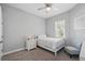 Cozy bedroom with natural light, neutral decor and comfortable furnishings at 3229 Medici Blvd, New Smyrna Beach, FL 32168