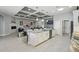 Open concept kitchen with stainless appliances, center island with seating and a view of the living area at 3229 Medici Blvd, New Smyrna Beach, FL 32168