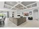 Spacious living room with modern tile flooring, fireplace, coffered ceilings and comfortable seating at 3229 Medici Blvd, New Smyrna Beach, FL 32168