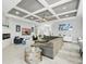 Bright living room featuring coffered ceilings, tile floors, comfortable seating and a modern fireplace at 3229 Medici Blvd, New Smyrna Beach, FL 32168