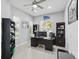 Spacious home office with modern desk, bookshelves, and natural light from the window overlooking the front yard at 3229 Medici Blvd, New Smyrna Beach, FL 32168