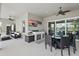 Covered outdoor kitchen and dining area adjacent to comfortable seating, with beautiful views at 3229 Medici Blvd, New Smyrna Beach, FL 32168