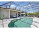Covered outdoor living space overlooking a screened pool with lounge chairs and outdoor kitchen at 3229 Medici Blvd, New Smyrna Beach, FL 32168
