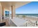 Spacious balcony featuring ocean views, a dining table, and seating perfect for relaxation and entertaining at 3245 S Atlantic Ave # 304, Daytona Beach Shores, FL 32118