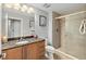 This bathroom features a glass enclosed shower, granite counters and modern fixtures at 3245 S Atlantic Ave # 304, Daytona Beach Shores, FL 32118