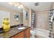 Bathroom with granite countertops, a vanity, and a tiled shower-tub combination at 3245 S Atlantic Ave # 304, Daytona Beach Shores, FL 32118