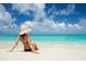 Relaxing on a white sand beach with blue skies and crystal-clear turquoise water at 3245 S Atlantic Ave # 304, Daytona Beach Shores, FL 32118