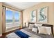 Bedroom with a large window providing ocean views, hardwood floors, and decorative artwork at 3245 S Atlantic Ave # 304, Daytona Beach Shores, FL 32118
