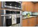 Kitchen features stainless oven and microwave with granite countertops and stainless sink at 3245 S Atlantic Ave # 304, Daytona Beach Shores, FL 32118